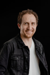 Portrait of a man with curly hair.