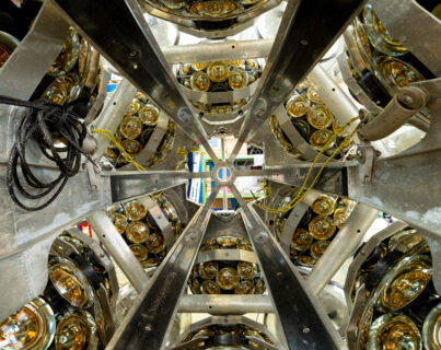 An assembled Digital Optical Module (DOM). Lower and upper half spheres coupled together to form a complete DOM with 31 light-sensitive PMTs. A titanium collar is placed around the glass sphere allowing to attach the DOM to the ropes which hold the DU vertically. (Image: Patrick Dumas)