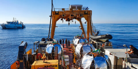 Four Dual Units (DU), rolled up over the Launcher Vehicle Moduls (LOM), are ready for deployment to the deep sea. They are covered with reflective sheets to shade the light-sensitive PMTs inside the Digital Optical Modules (DOM) . (Image: C. Lastoria_CPPM_CNRS)