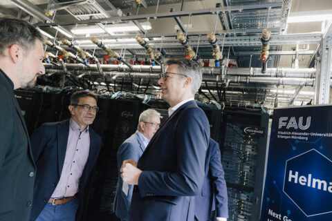 Minister of State Blume visits the NHR@FAU to take a look at the new graphics processors of the HELMA supercomputer. (Image: FAU/Giulia Iannicelli)